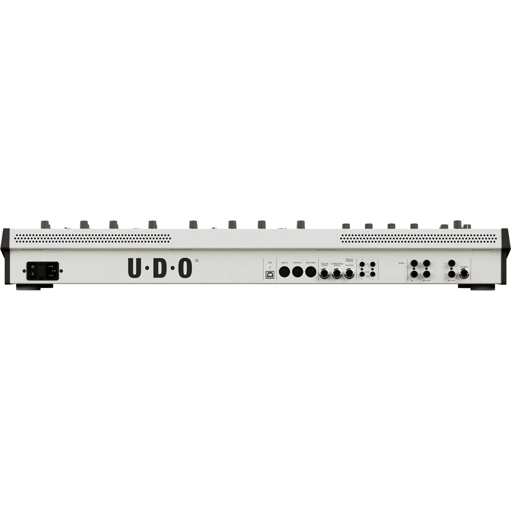 UDO Audio DMNO keyboard synthesizer with black and silver controls, display screen, and various knobs and buttons for sound editing.