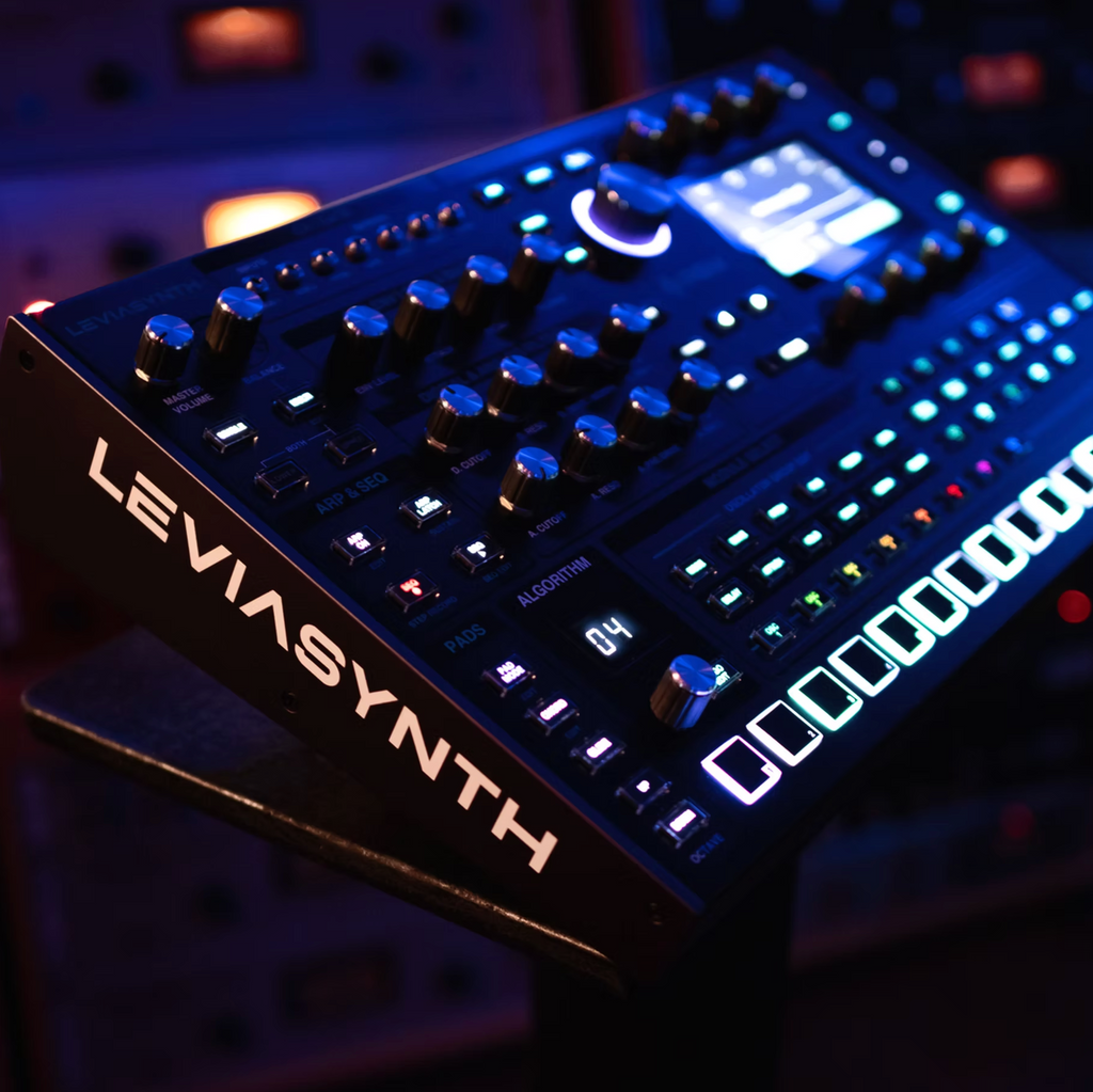ASM Leviasynth desktop synthesizer with knobs, buttons, and display panel, showcasing its compact design and control interface.
