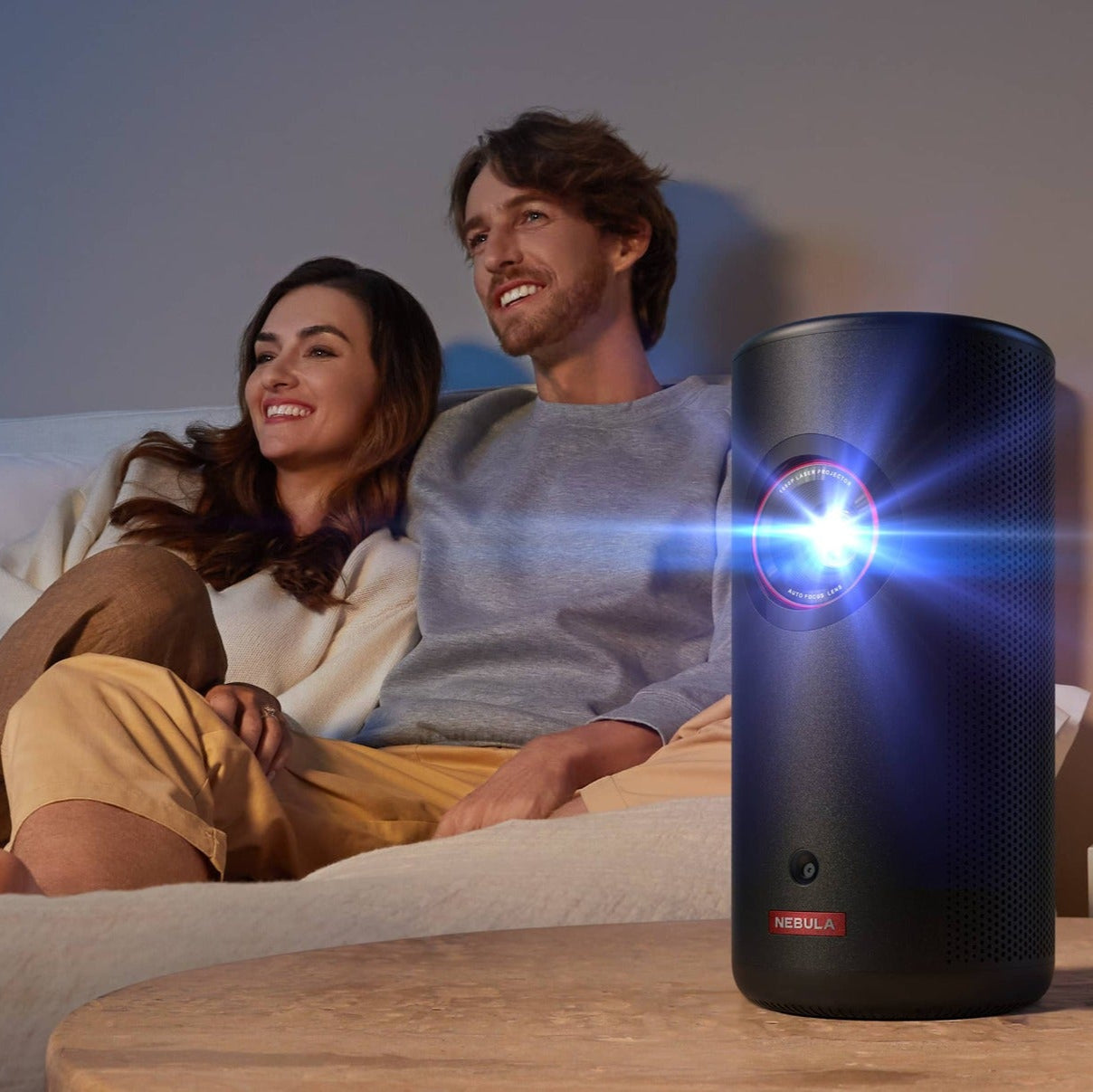Nebula Capsule 3 Laser projector displaying a colorful image on a wall, compact design with lens and control buttons visible.
