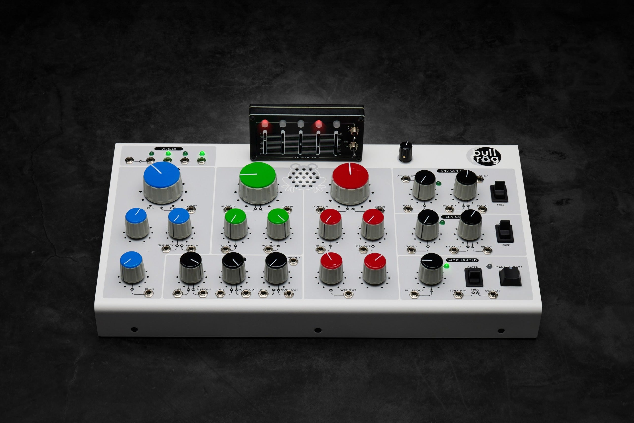 Erica Synths Bullfrog desktop synthesizer with knobs, buttons, and patch points on a black panel with colorful accents.