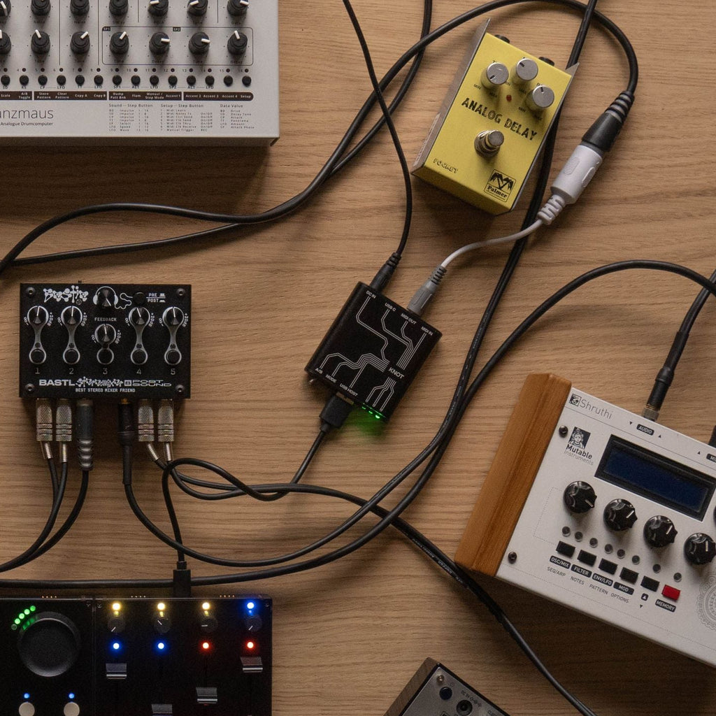 Intech Studio KNOT MIDI interface connected to audio equipment, showcasing its compact design and connectivity ports.
