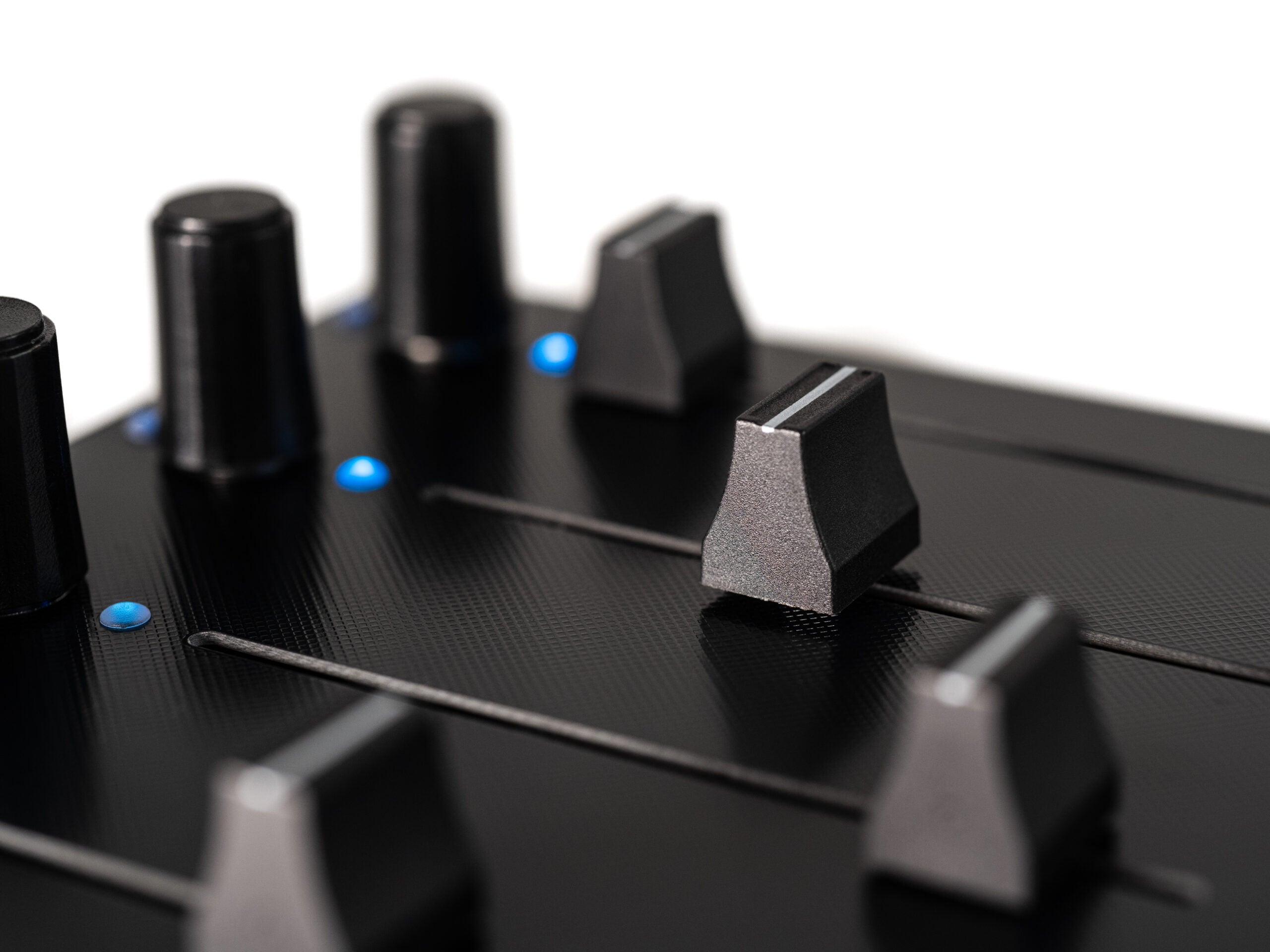 Close-up of Intech Studio EF44 Detent Series 3 MIDI controller with knobs and buttons, showing detailed control surface.