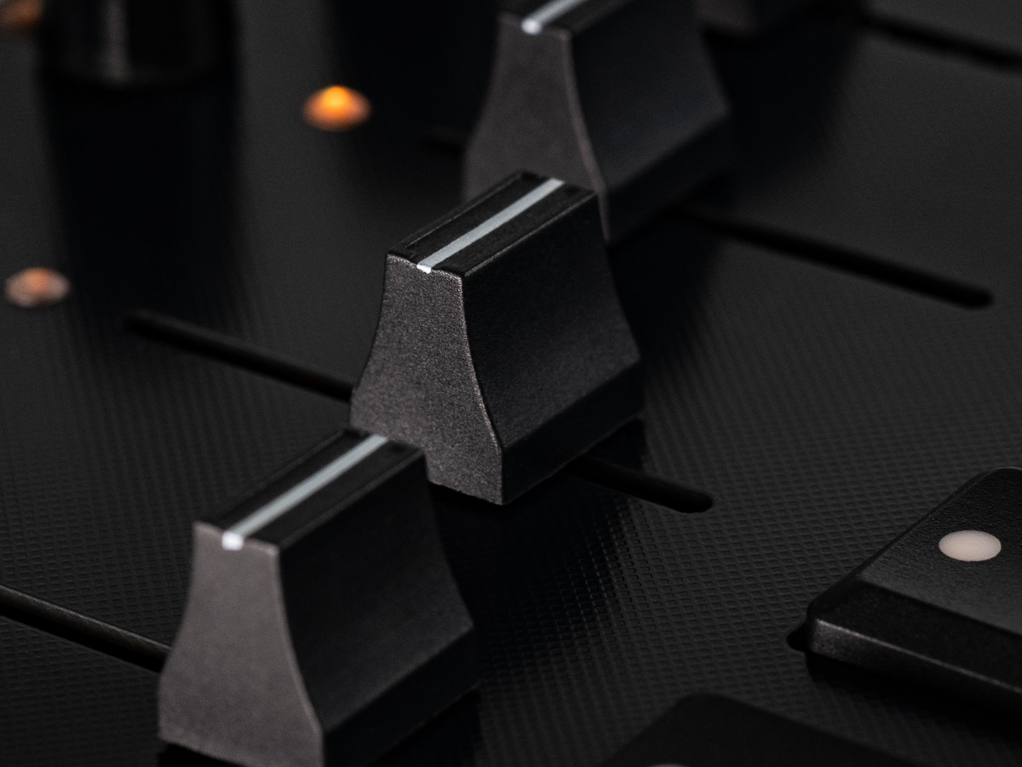 Close-up of Intech Studio PBF4 Series 3 MIDI controller with linear mechanical faders and controls.