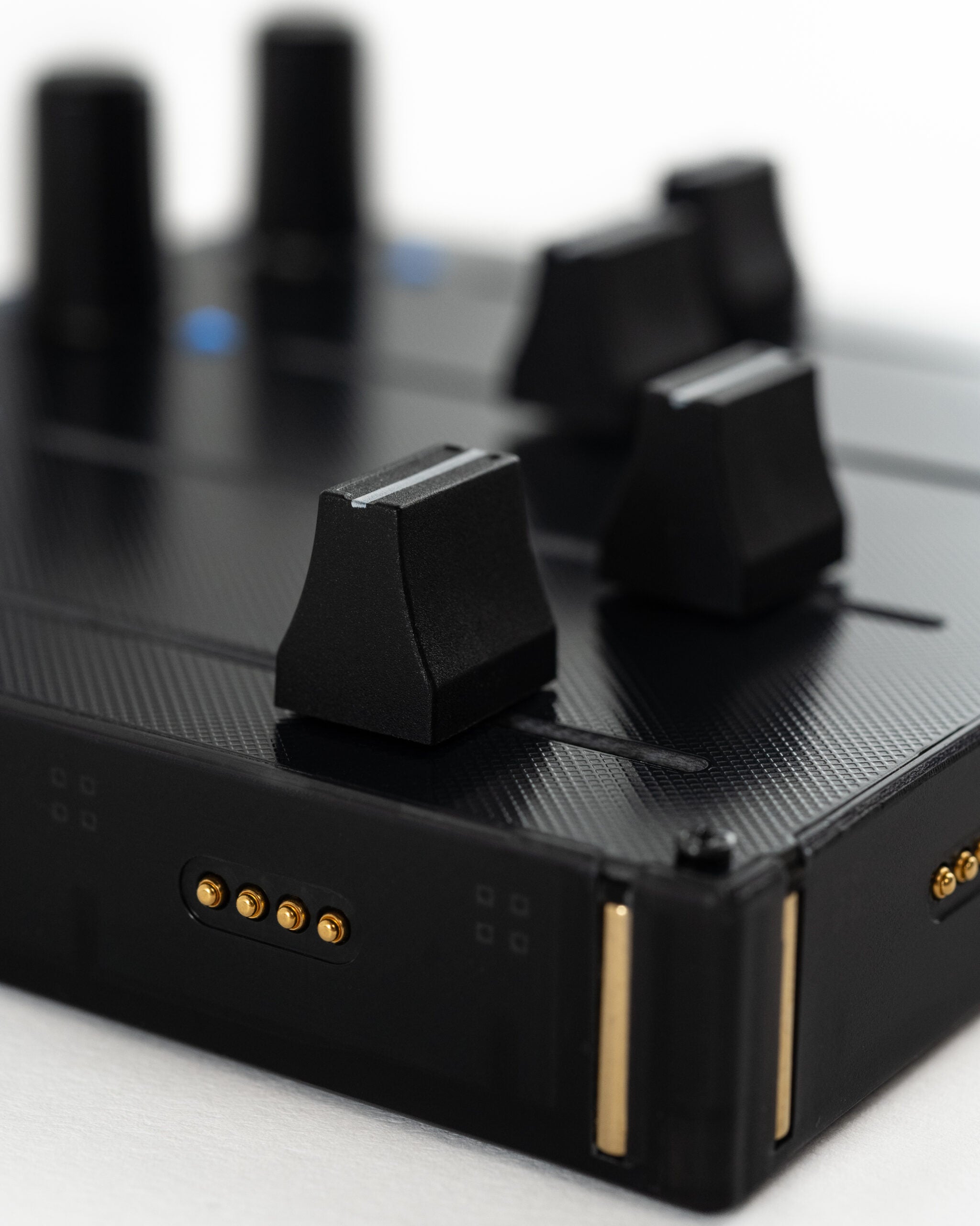 Close-up of Intech Studio EF44 Detent Series 3 MIDI controller with knobs and switches for music production.