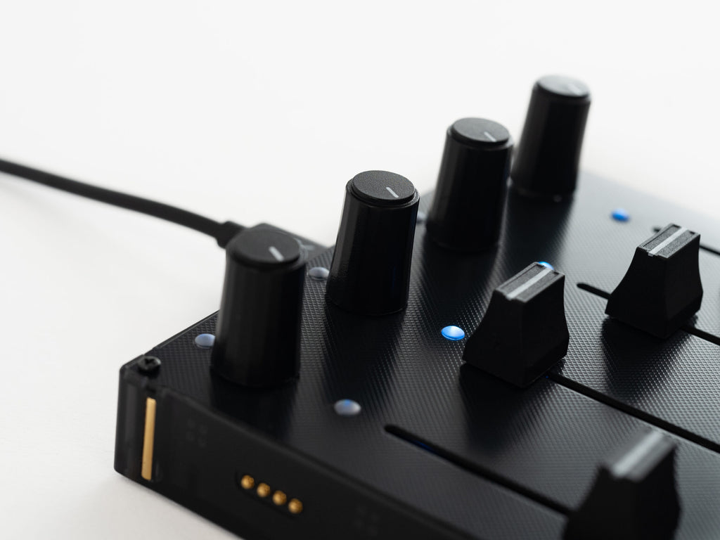 Close-up of Intech Studio EF44 Detent Series 3 MIDI controller with numbered knobs and controls, showing detailed interface.