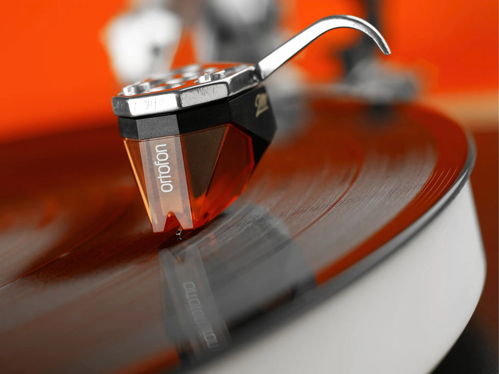 Ortofon 2M Bronze turntable cartridge with stylus, black body and silver tone, designed for high-quality vinyl record playback.