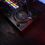 Black Reloop RP-7 DJ turntable with professional tonearm and control features, designed for high-quality DJ mixing.