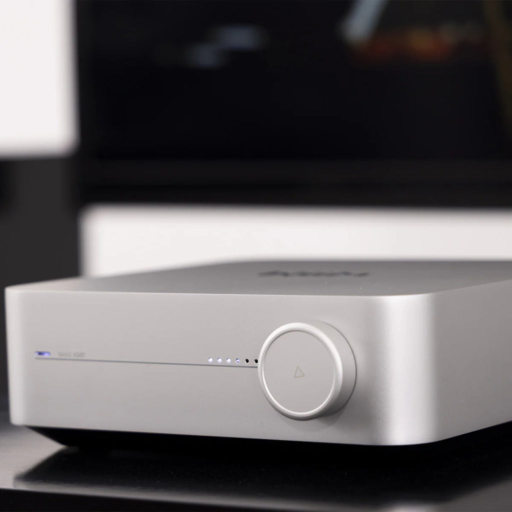 WiiM AMP music streamer device with sleek black design and multiple connectivity ports, perfect for high-quality audio streaming.