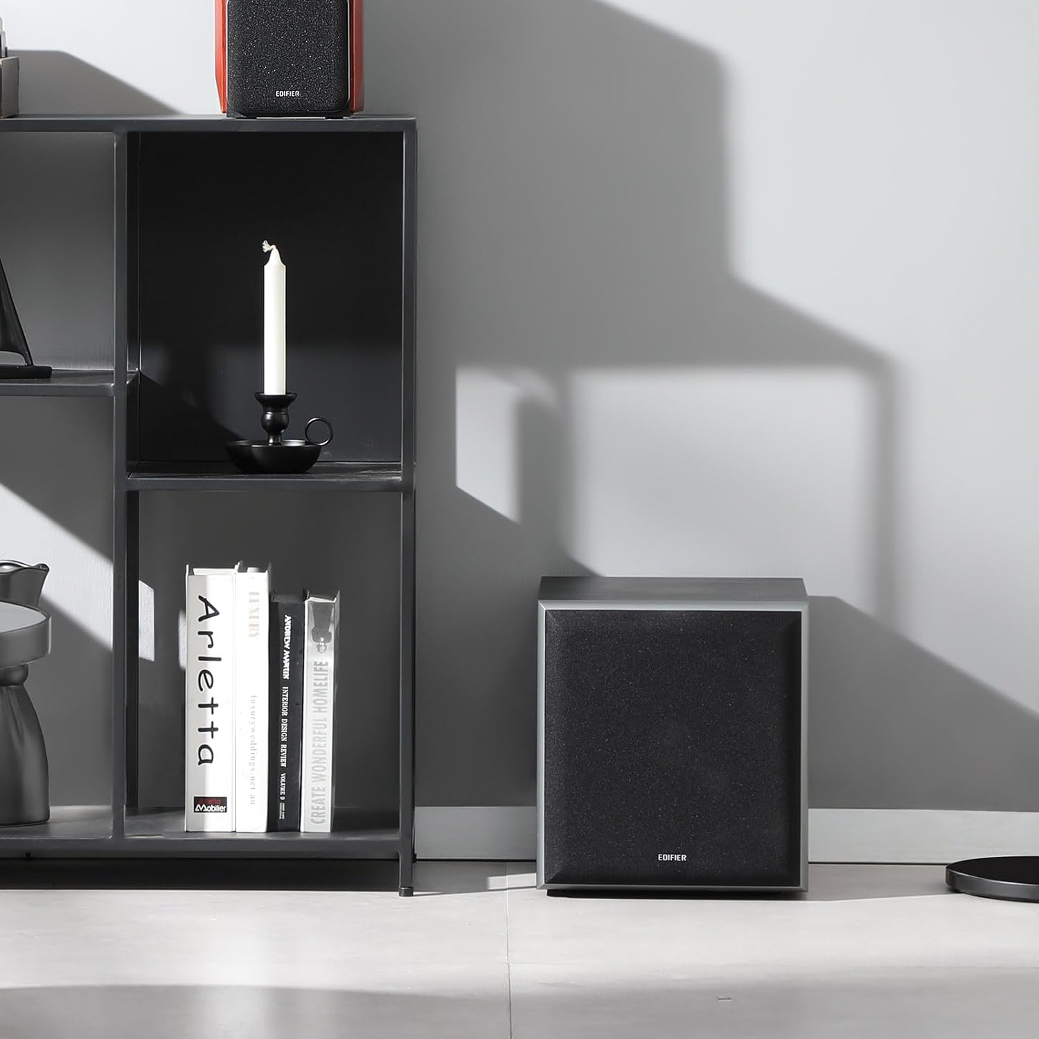 Edifier T5 powered subwoofer with sleek black design and control panel, designed for deep bass sound.