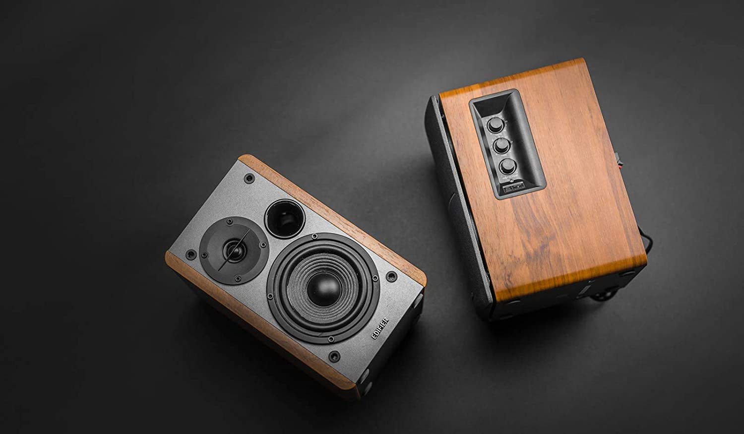 Edifier R1280DBS desktop speakers with wood finish and control knobs on the side, designed for high-quality audio.