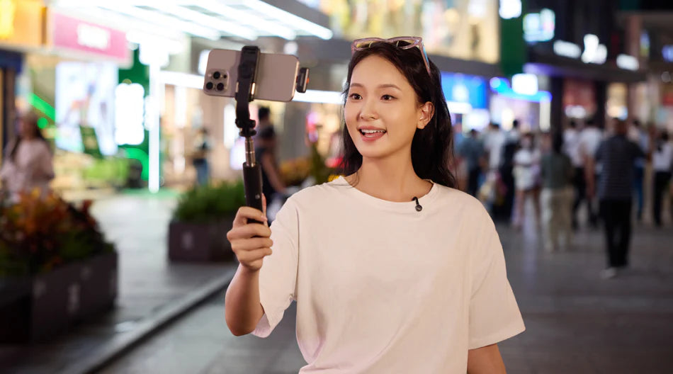 Hollyland Lark M2S Ultimate Combo wireless microphone system with camera, USB-C, and Lightning connectors, showing noise-cancellation scene.
