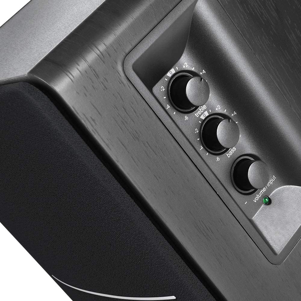 Edifier R1280DBS desktop speakers with wooden finish and control knobs on the front, connected to a computer setup.