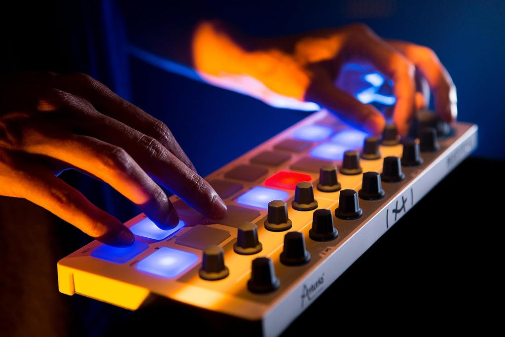 Arturia BeatStep sequencer with control pads and knobs on a black compact device, used for music production and live performance.