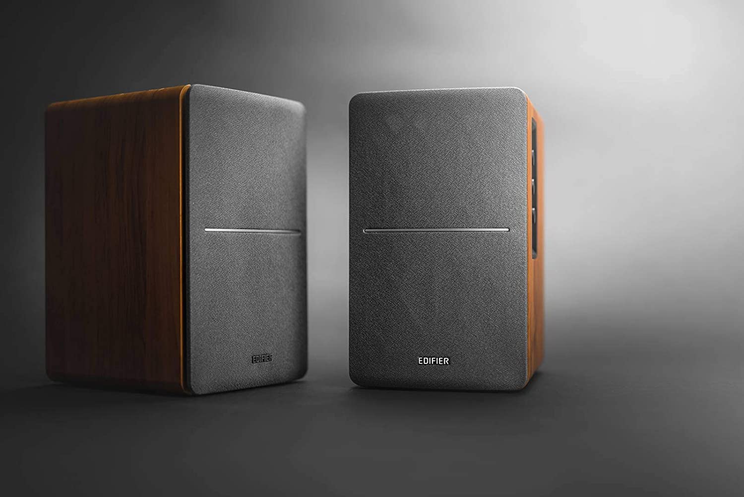 Edifier R1280DBS desktop speakers with wood finish and control knobs on the side, designed for high-quality audio.