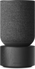 Bang & Olufsen Beosound Balance wireless speaker with sleek design and premium wood finish, featuring touch controls and fabric grille.