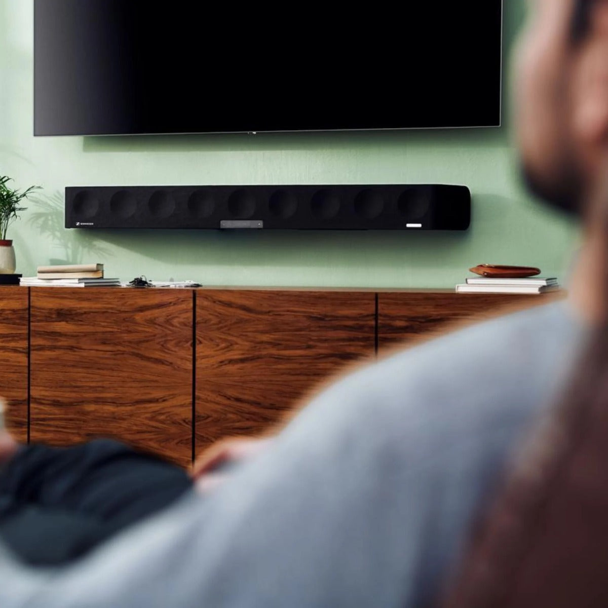 Sennheiser Ambeo Soundbar Max with sleek black design, multiple speaker drivers, and control buttons on the top for immersive TV sound.