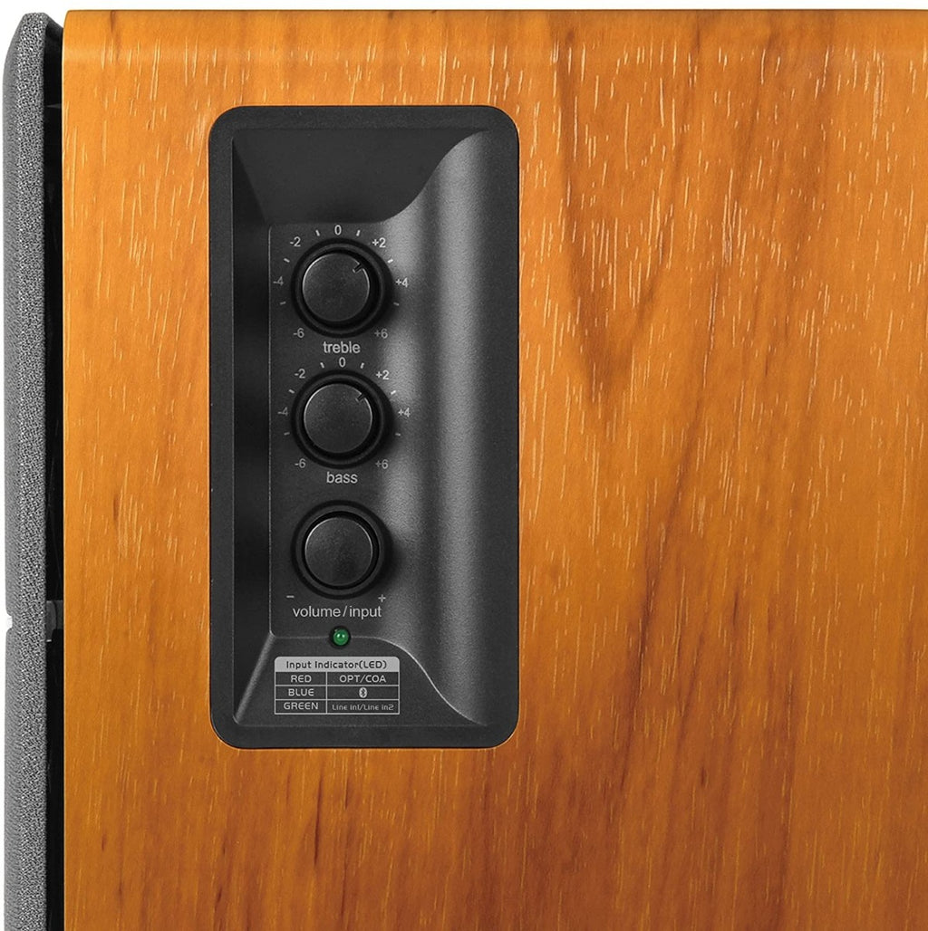 Edifier R1280DBS desktop speakers with wooden finish and control knobs, designed for high-quality audio on a computer desk.