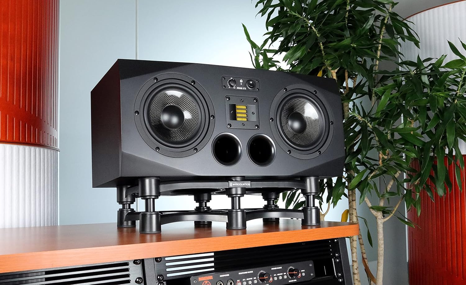 IsoAcoustics ISO-430 studio monitor stands supporting audio monitors on a desk with a sleek black design.