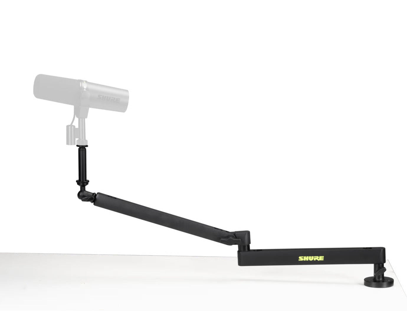 Shure SH-BROADCAST2 broadcast microphone arm mounted on a desk, adjustable arm for professional podcast or studio microphone setup.