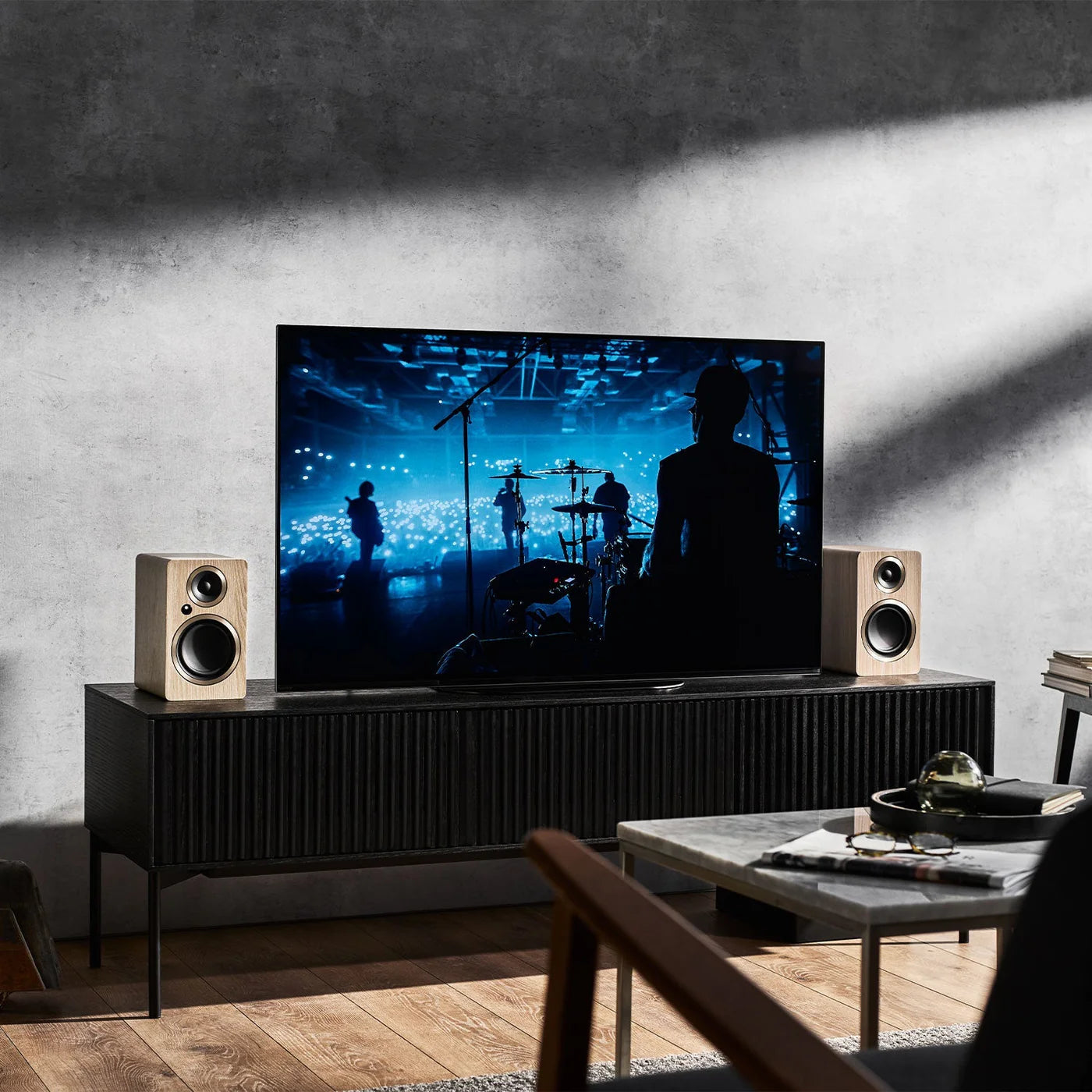 Argon Audio Fenris A4 active bookshelf speakers in black with wood finish, showing the front view with drivers and control knobs.
