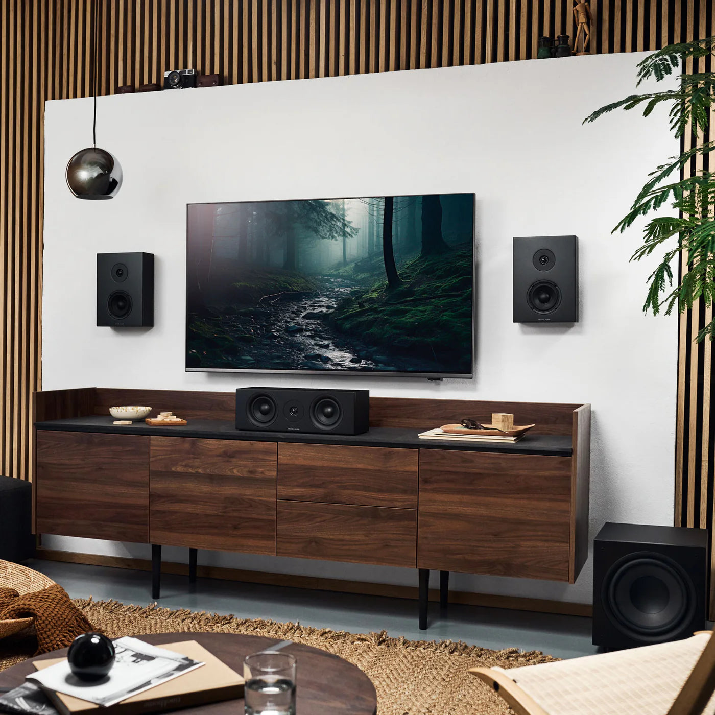 Argon Audio Forus 4 wall and outdoor speakers in black, showing sleek design and mounting brackets for in-wall installation.