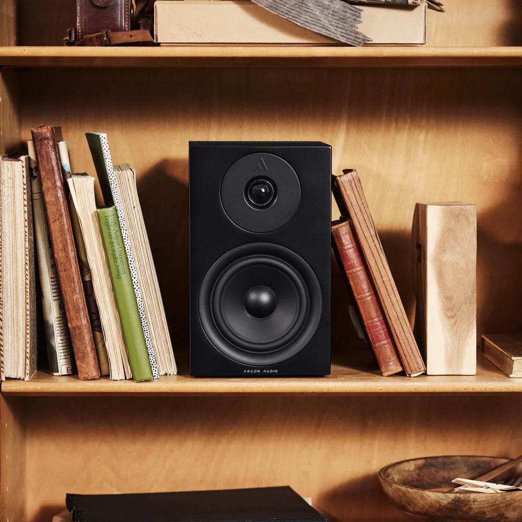Argon Audio Forus 5 passive bookshelf speakers shown in black with wood finish, featuring sleek design and front-facing speaker drivers.