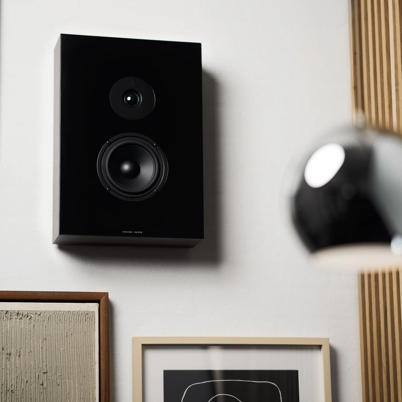 Argon Audio Forus 5 wall-mounted in-wall and outdoor speakers installed on a wall, designed for seamless outdoor audio.