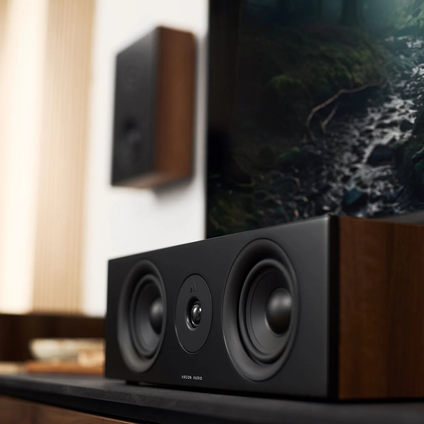 Argon Audio Forus Center speaker in white, showcasing its sleek design and front grille for home theater audio setup.