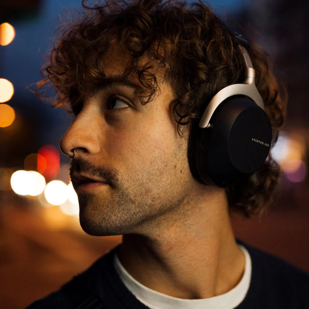 Beyerdynamic Aventho 300 wireless headphones in a lifestyle setting, showing black over-ear design and comfortable ear cushions.