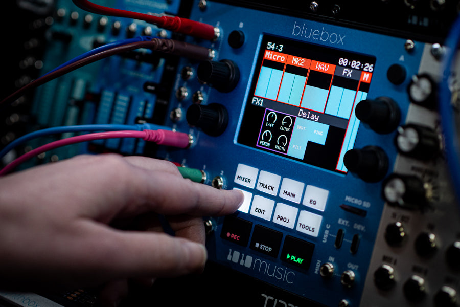 1010music Bluebox Eurorack semi-modular synthesizer with colorful knobs and patch points, designed for versatile sound creation.