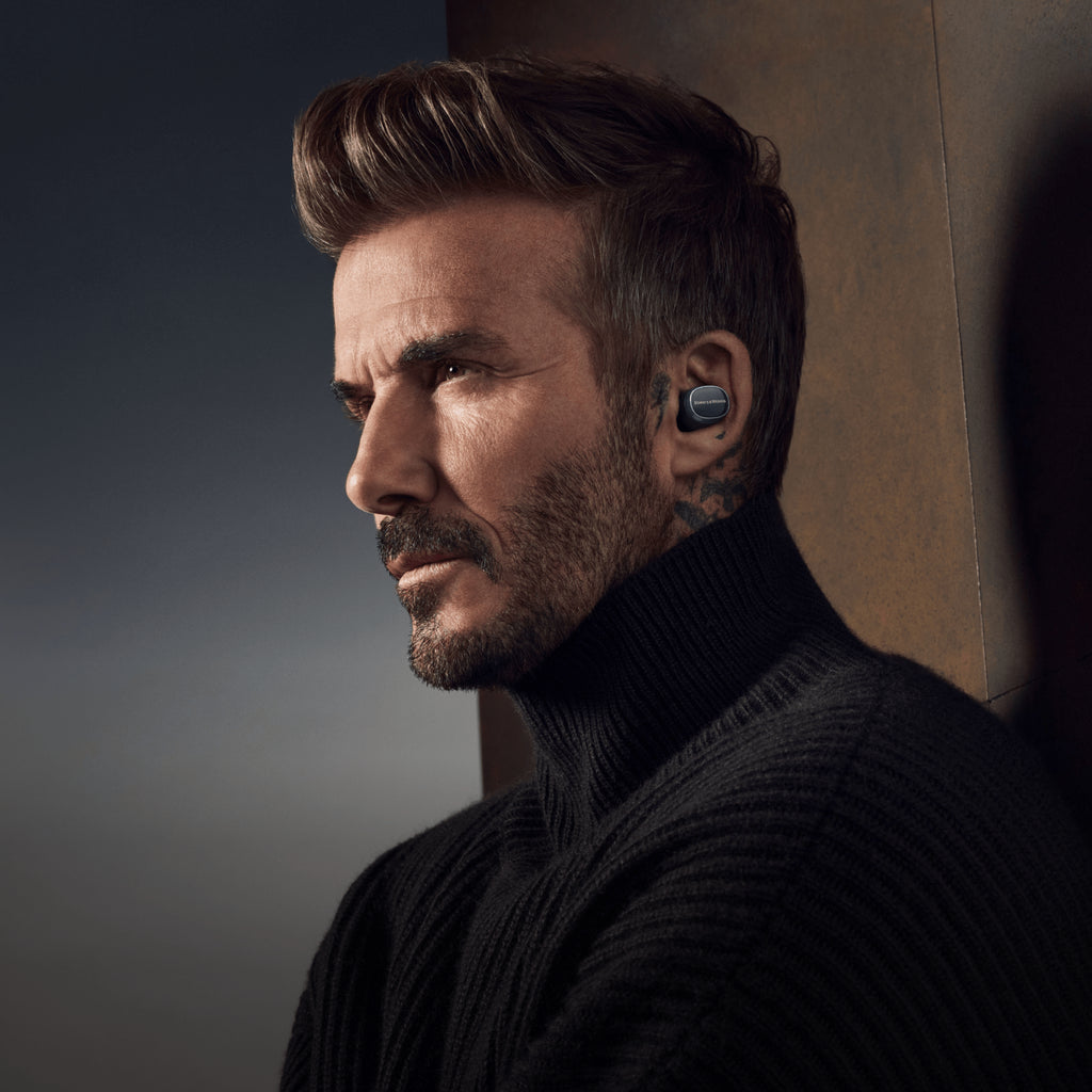 Wireless in-ear headphones by Bowers & Wilkins Pi8 model, showcasing sleek design and compact earbuds on a dark background.