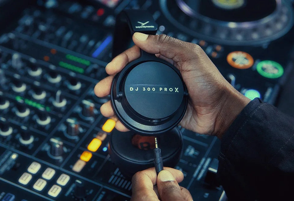 Beyerdynamic DJ 300 Pro X DJ headphones with a coiled cable, black over-ear design, and adjustable headband for professional DJ use.