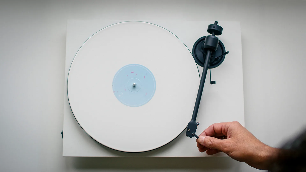 Pro-Ject E1.2 turntable in a modern lifestyle setting, showcasing its sleek design and high-quality build for vinyl listening.