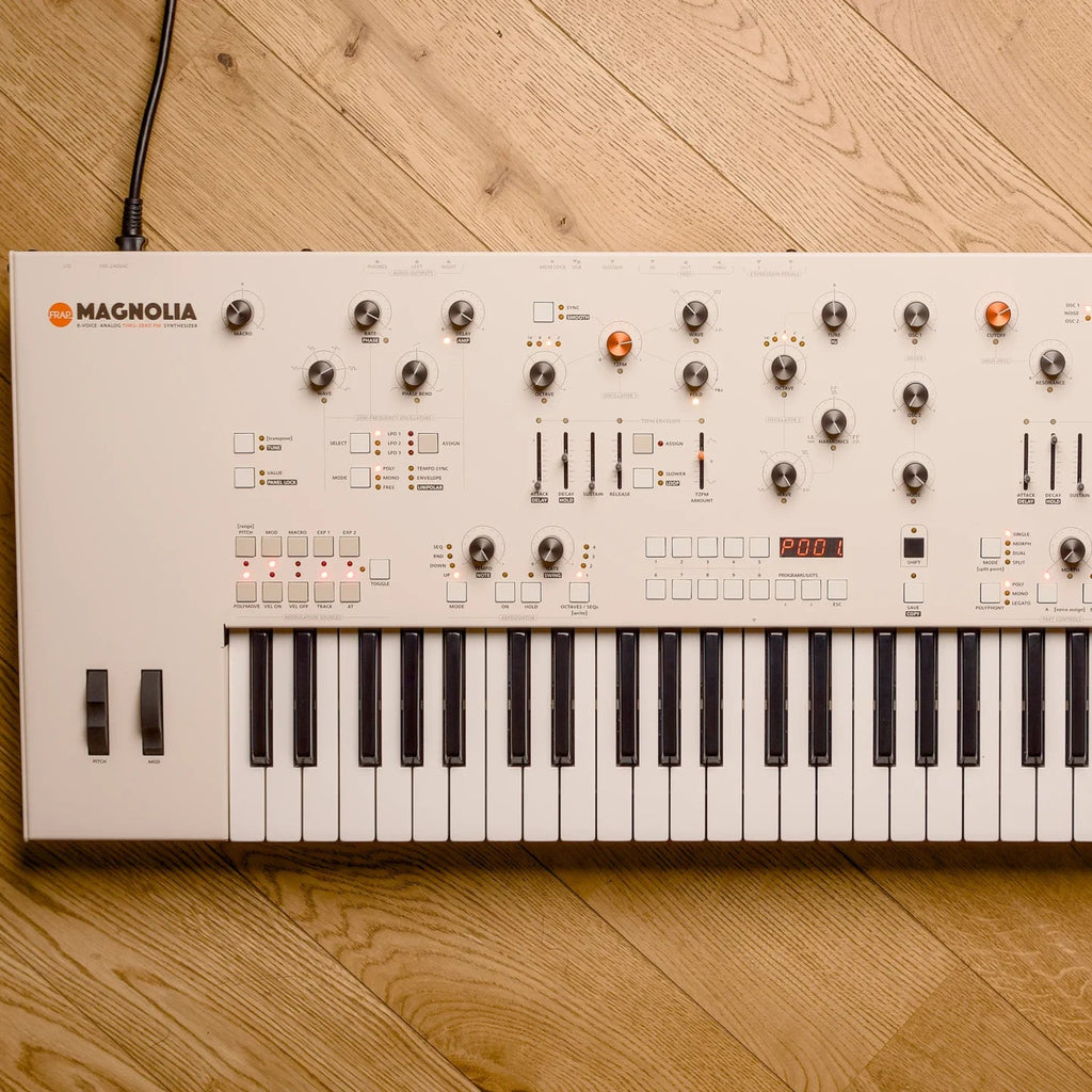 Frap Tools Magnolia keyboard synthesizer with control knobs and interface, top view showing its sleek design and layout.