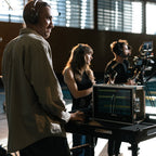 Hollyland Solidcom SE Pro remote headset for professional video communication, shown in a group setting with multiple headsets.