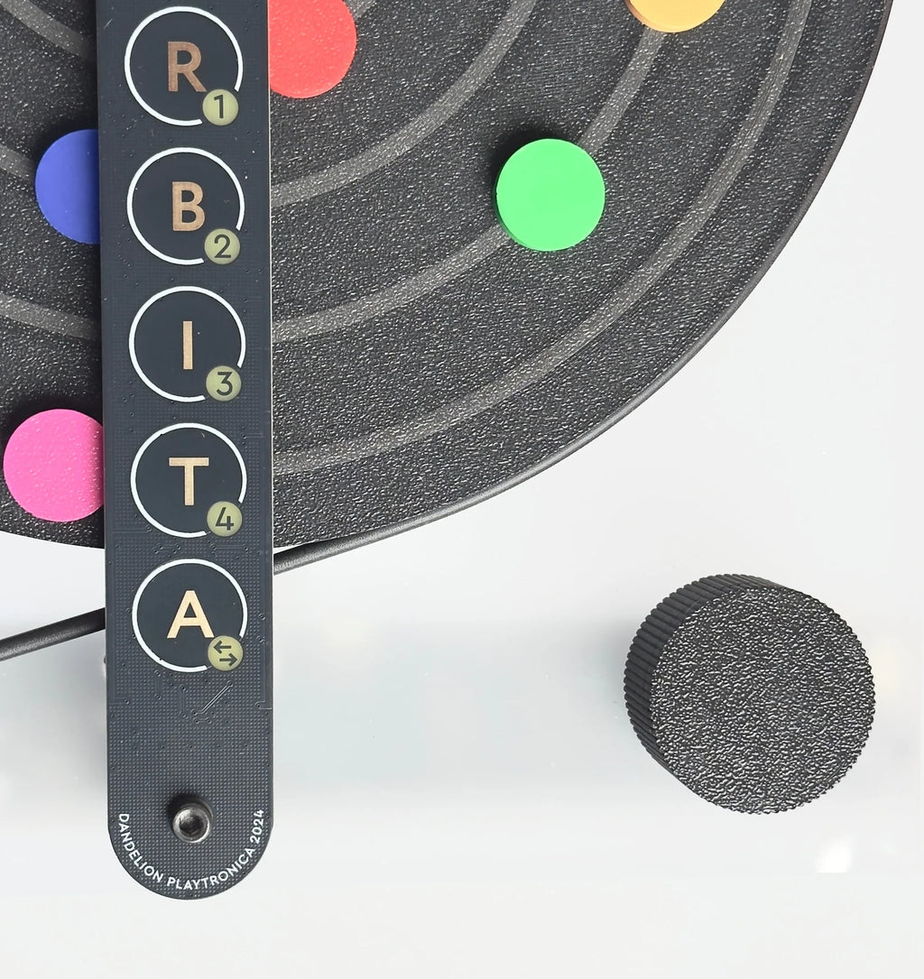 Playtronica Orbita gadget from Playtronica, featuring a sleek, modern design with colorful controls and a circular interface.