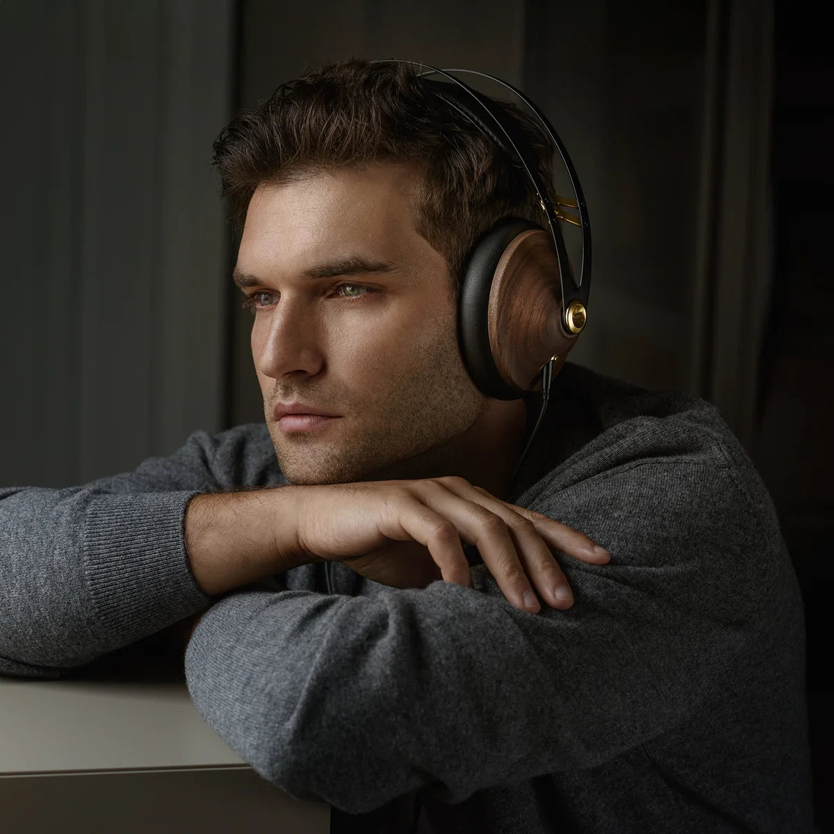 Meze Audio 99 Classics 2nd Gen wired headphones with wooden ear cups and comfortable headband, shown from a side angle.