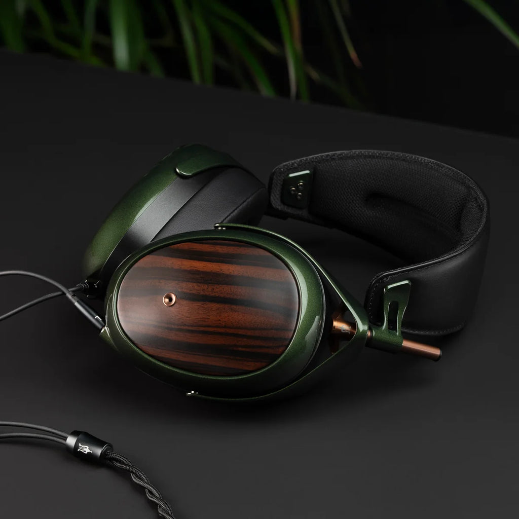 Close-up of Meze Audio Strada wired headphones showing sleek black design and comfortable ear cushions.