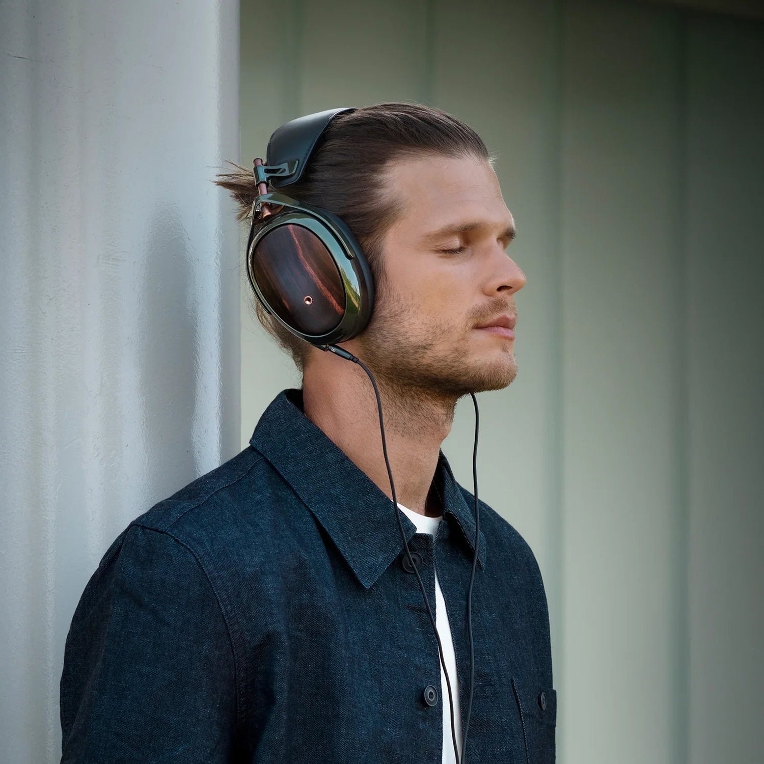 Meze Audio Strada wired headphones with sleek design and cushioned ear cups, featuring a black and silver finish.