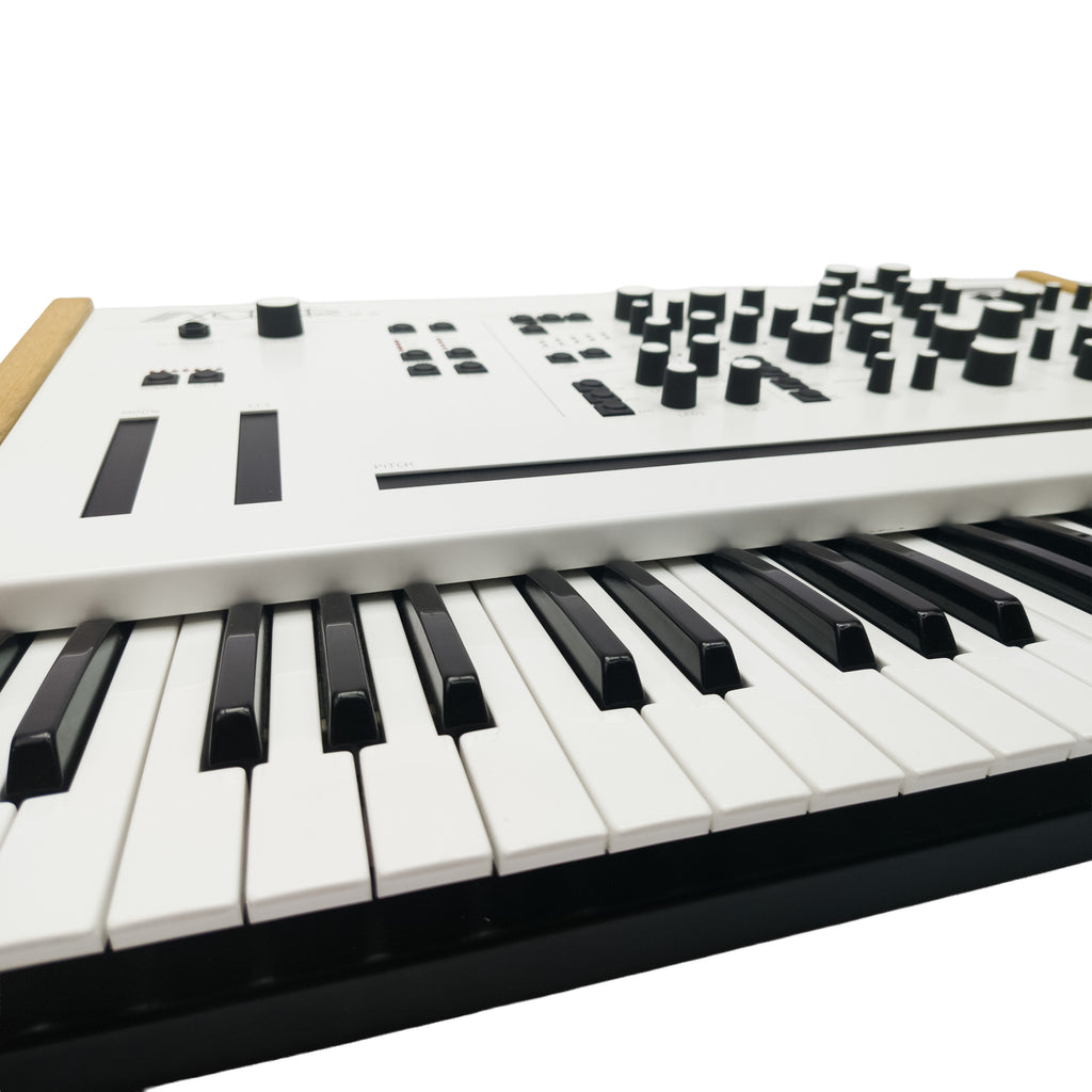Modor NF-1k keyboard synthesizer with compact design, multiple control knobs, and OLED display for versatile sound creation.