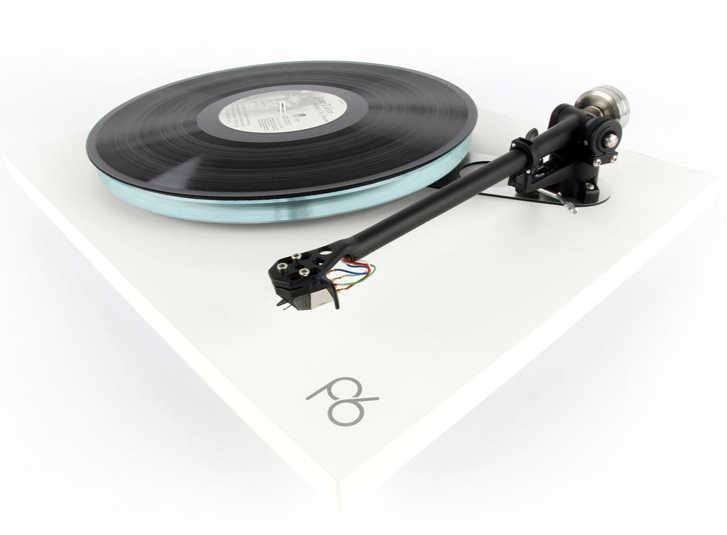 Rega ND5 turntable cartridge mounted on a turntable, showcasing its sleek design and branding.