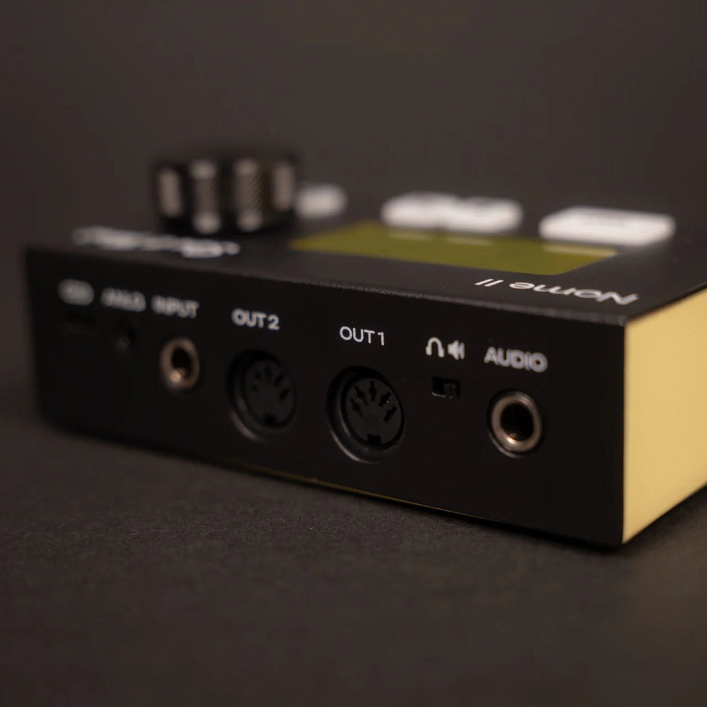 Sim'n Tonic Nome II MIDI interface shown from the back, featuring multiple input and output ports for music production.