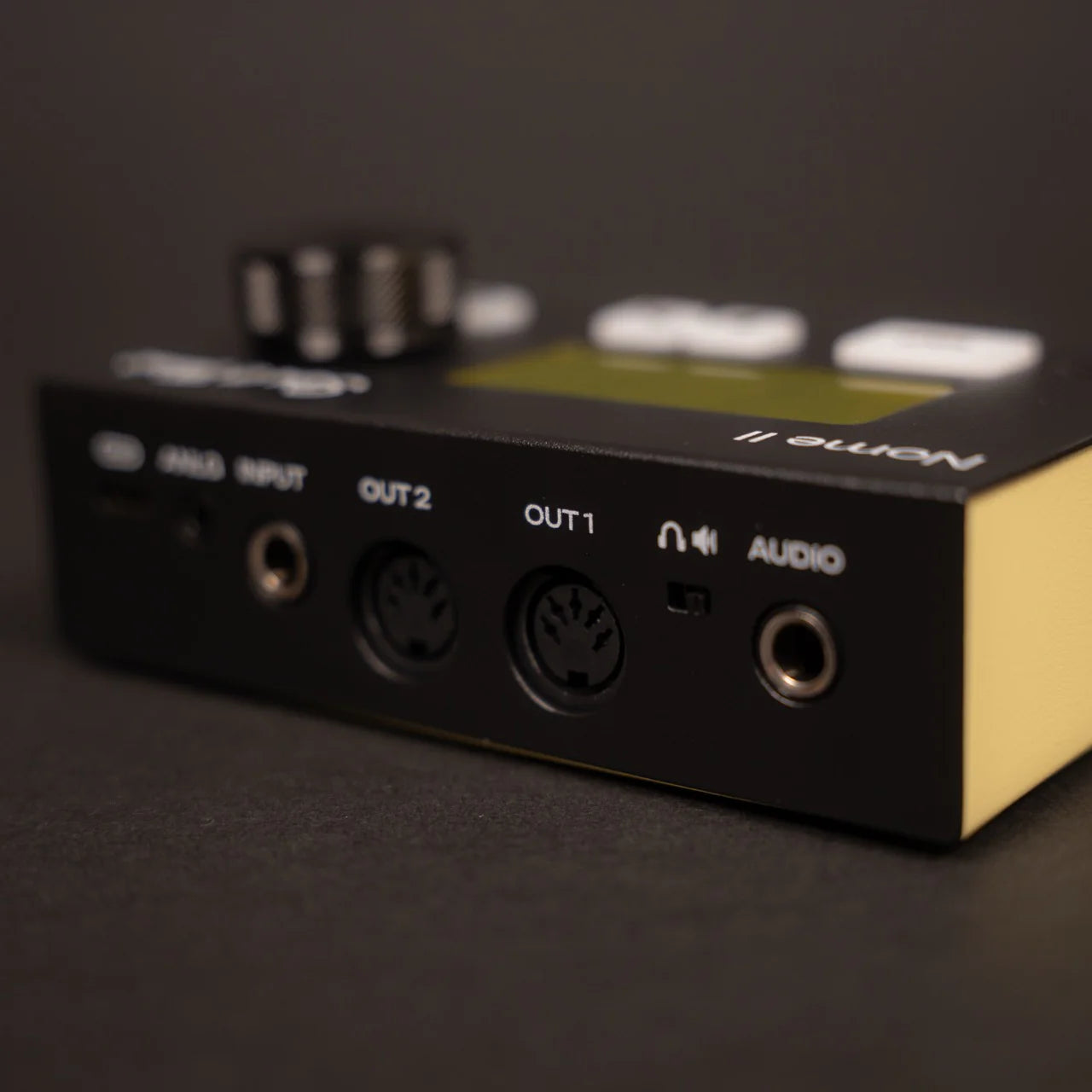 Sim'n Tonic Nome II MIDI interface shown from the back, featuring multiple input and output ports for music production.