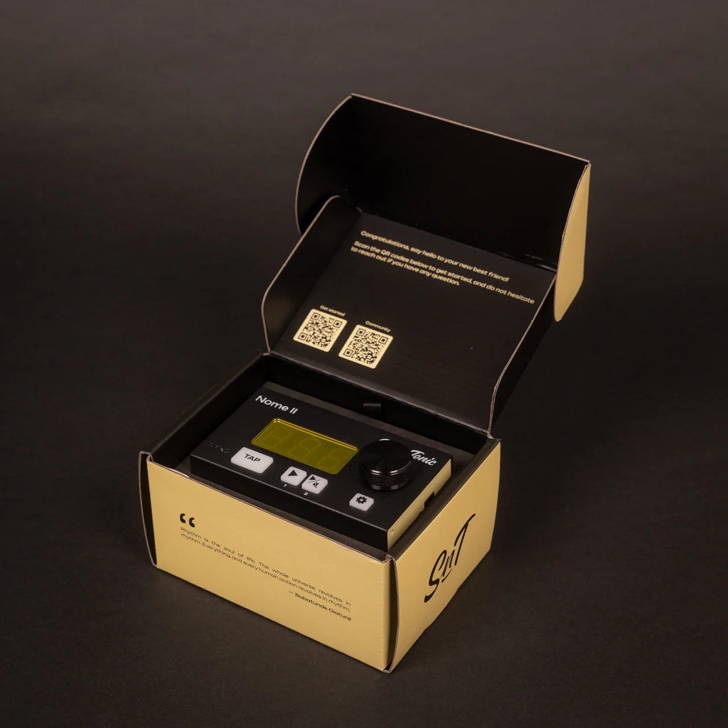 Open packaging of the Sim'n Tonic Nome II MIDI interface showing the device and its connecting ports.
