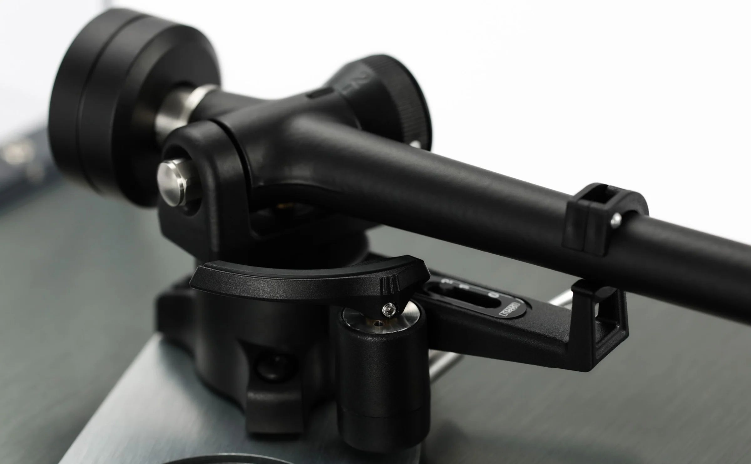 Close-up of Rega Planar 3 RS turntable with aluminum platter and Nd5 cartridge, showing detailed bias housing.