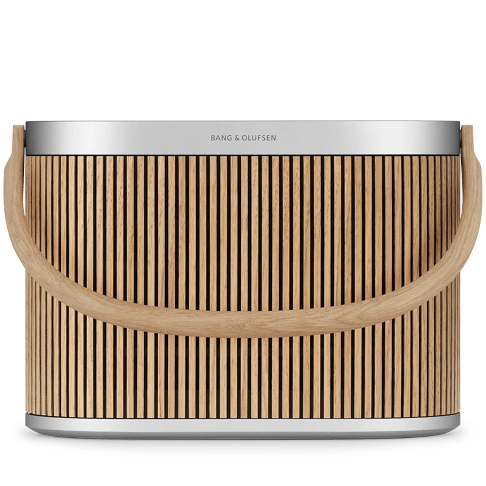 Bang & Olufsen Beosound A5 portable speaker in oak with a sleek front design, showcasing its modern and stylish appearance.