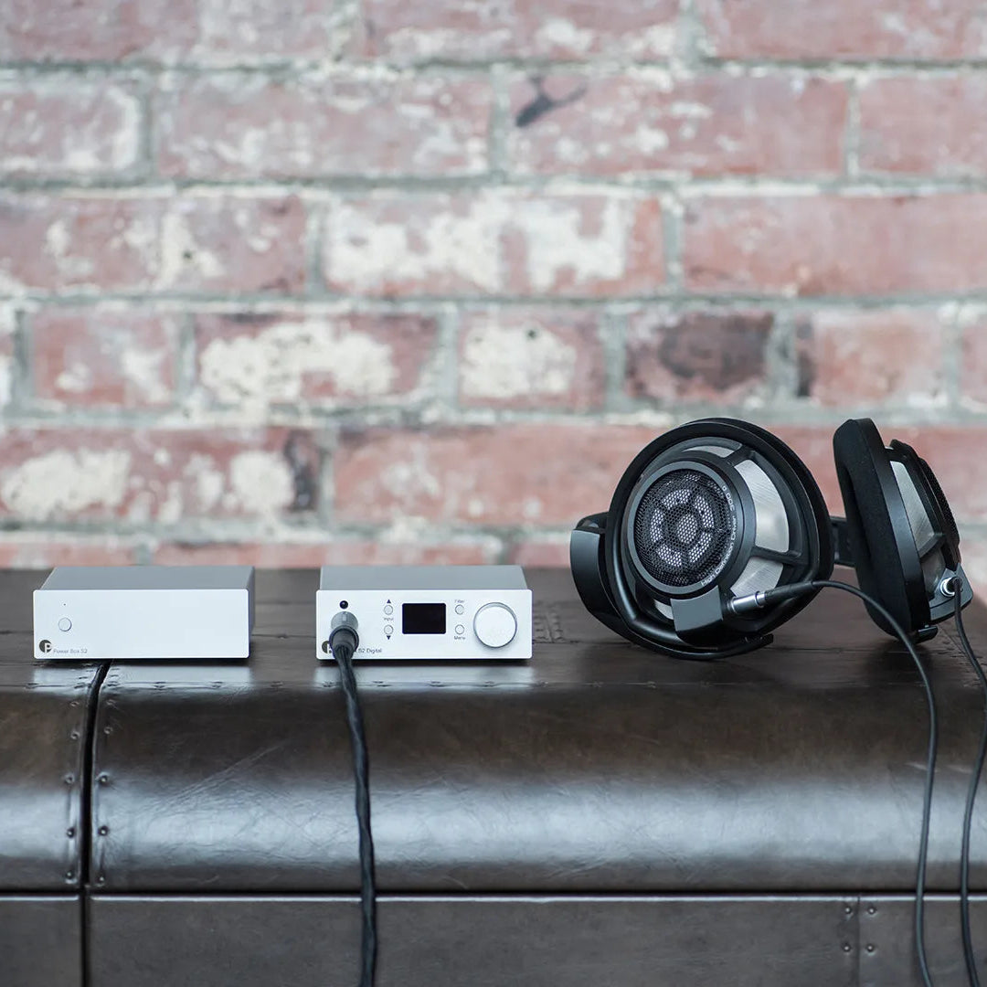 Pro-Ject Pre Box S2 Digital Edition 23 headphone amplifier and DAC with sleek black design and various input ports.