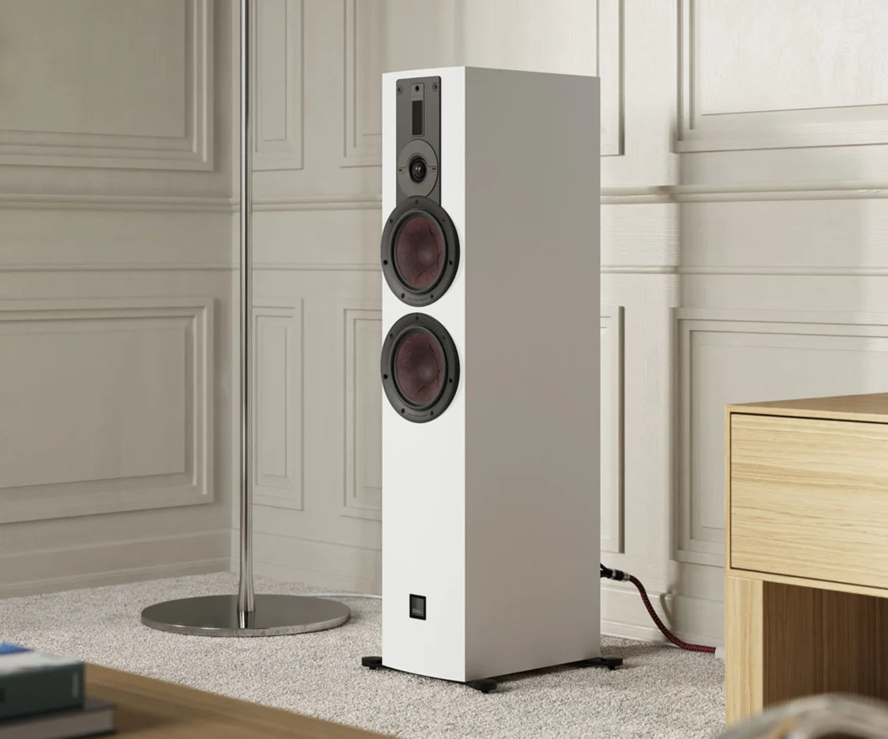 DALI Rubikore 6 passive floorstanding speakers in a living room setting, showcasing sleek black cabinets and modern design.