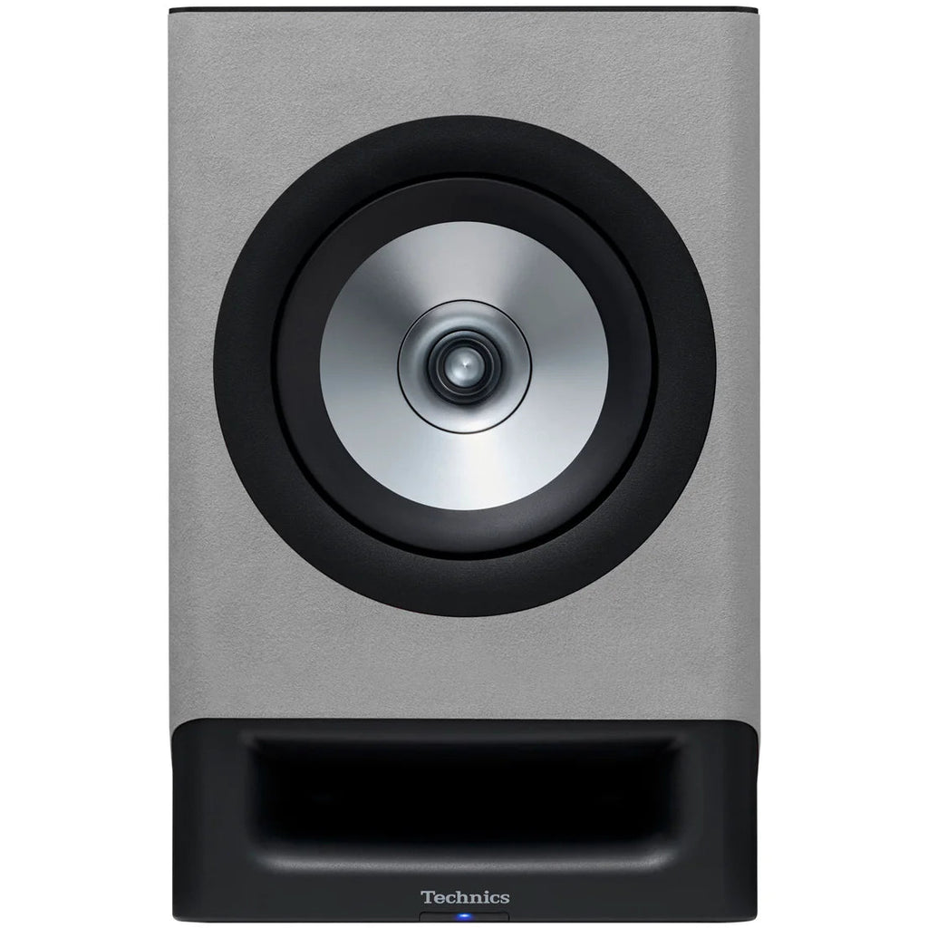Technics SC-CX700 active bookshelf speakers in gray, showing the front view with speaker grilles and sleek design.