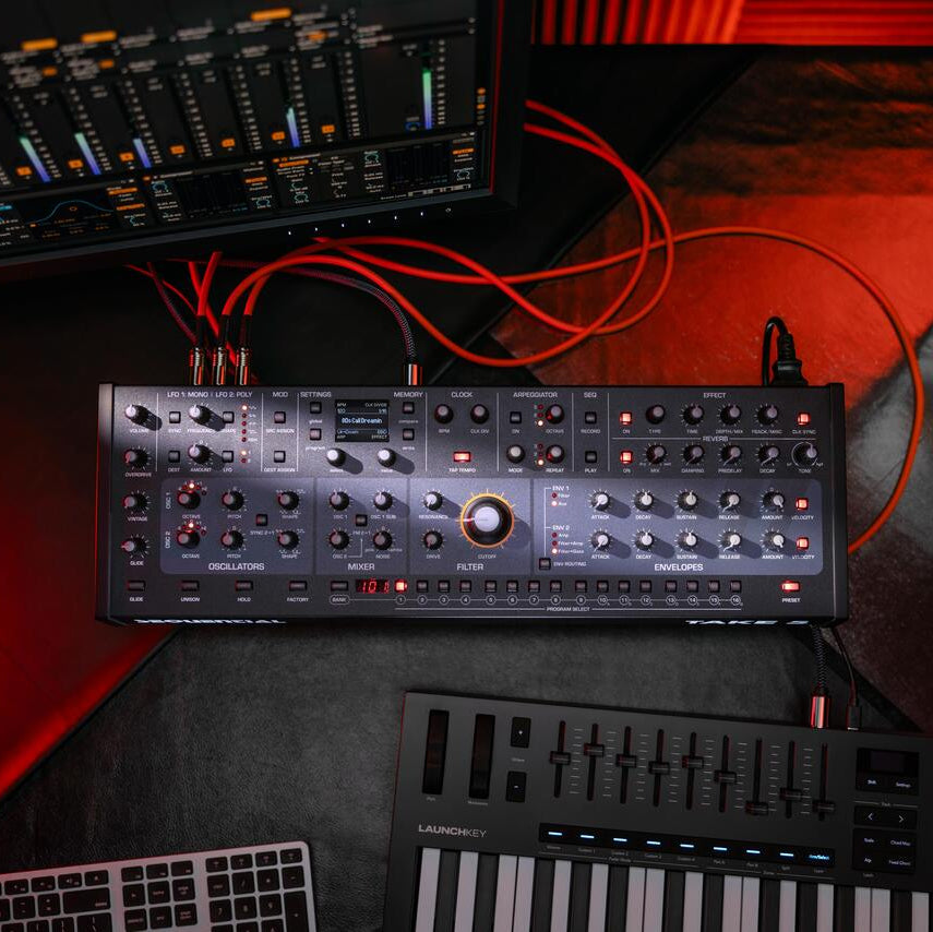 Sequential Take 5 Desktop synthesizer shown with controls and keyboard interface on a sleek black unit.